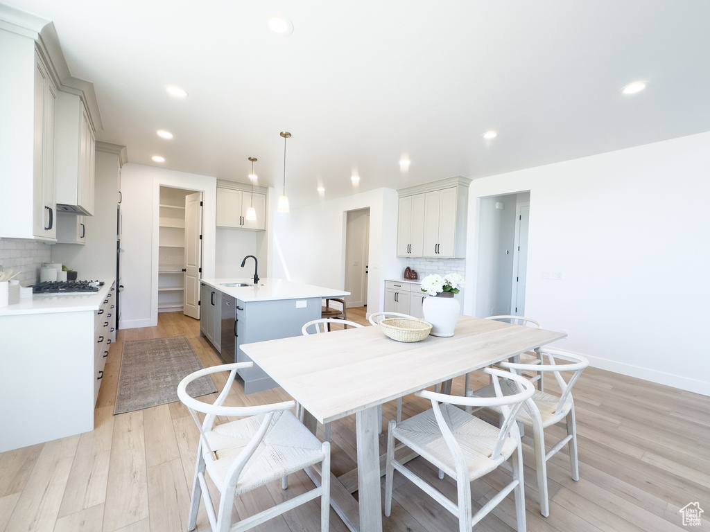 Dining room featuring sink and light hardwood / wood-style floors