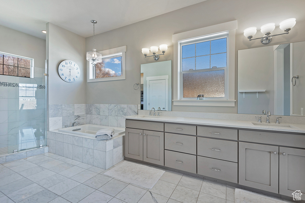 Bathroom featuring dual bowl vanity, plus walk in shower, and tile flooring