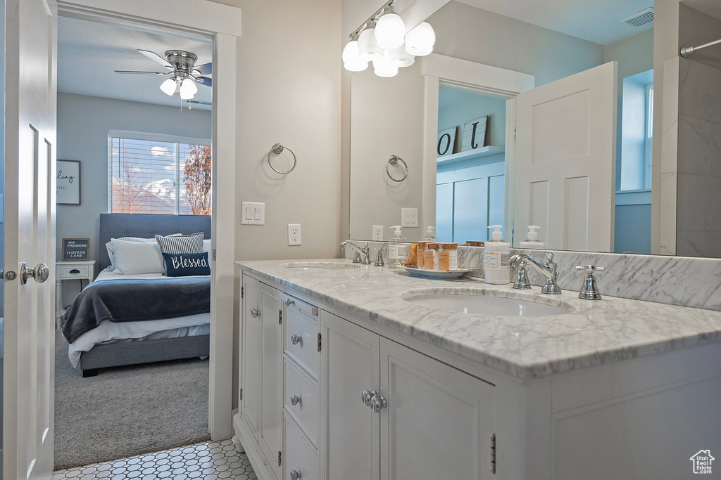 Bathroom featuring dual vanity, tile flooring, and ceiling fan