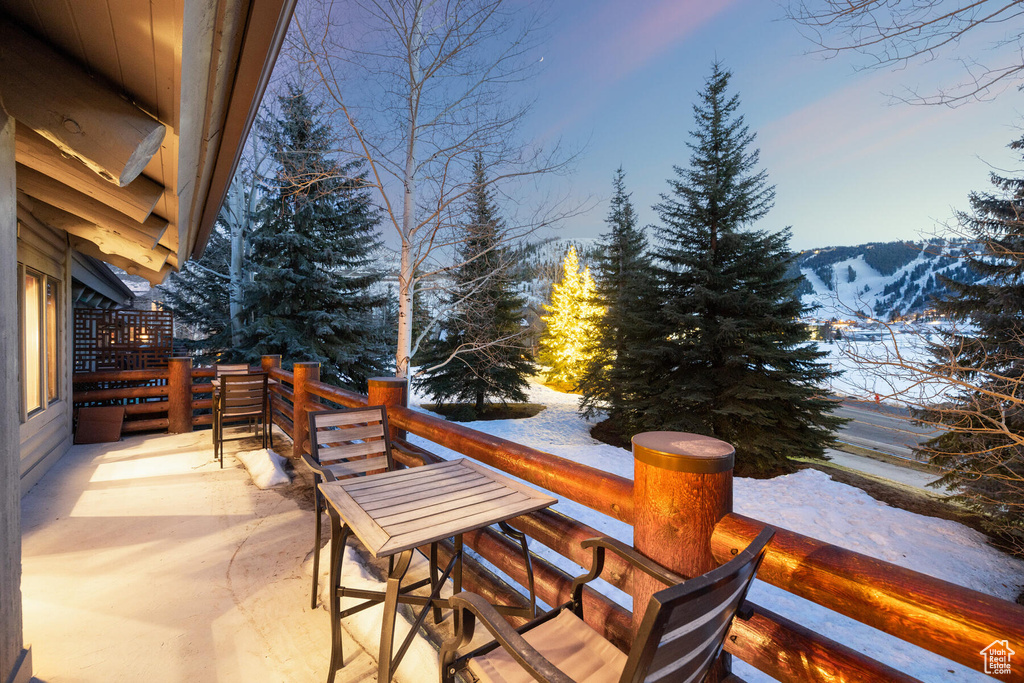 Snow covered patio featuring a mountain view