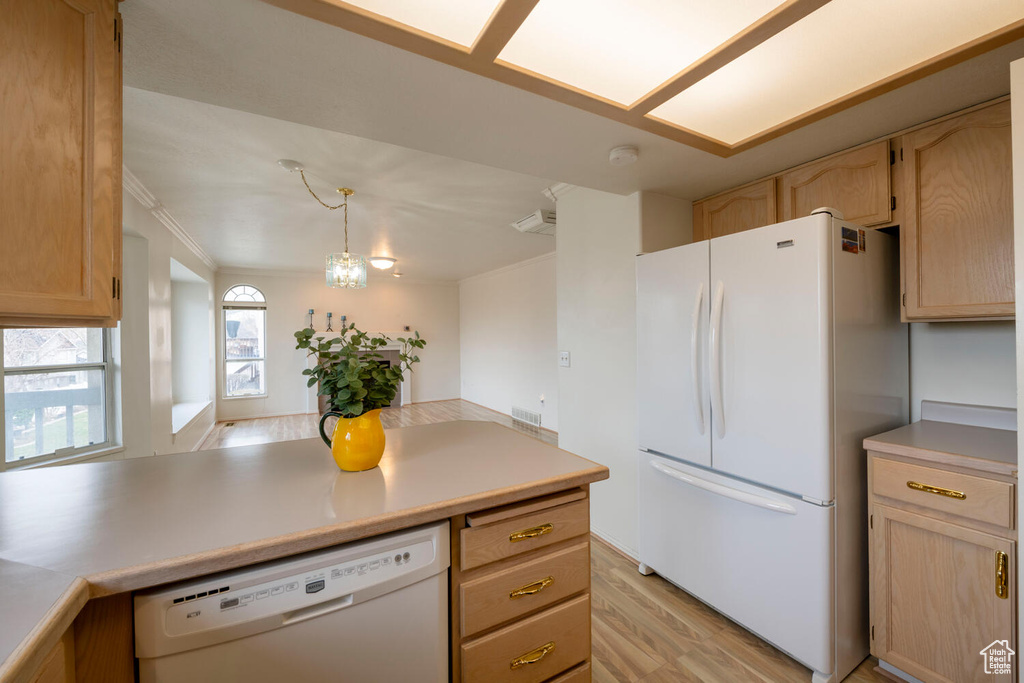 Kitchen featuring crown molding, light brown cabinets, white appliances, and light hardwood / wood-style floors