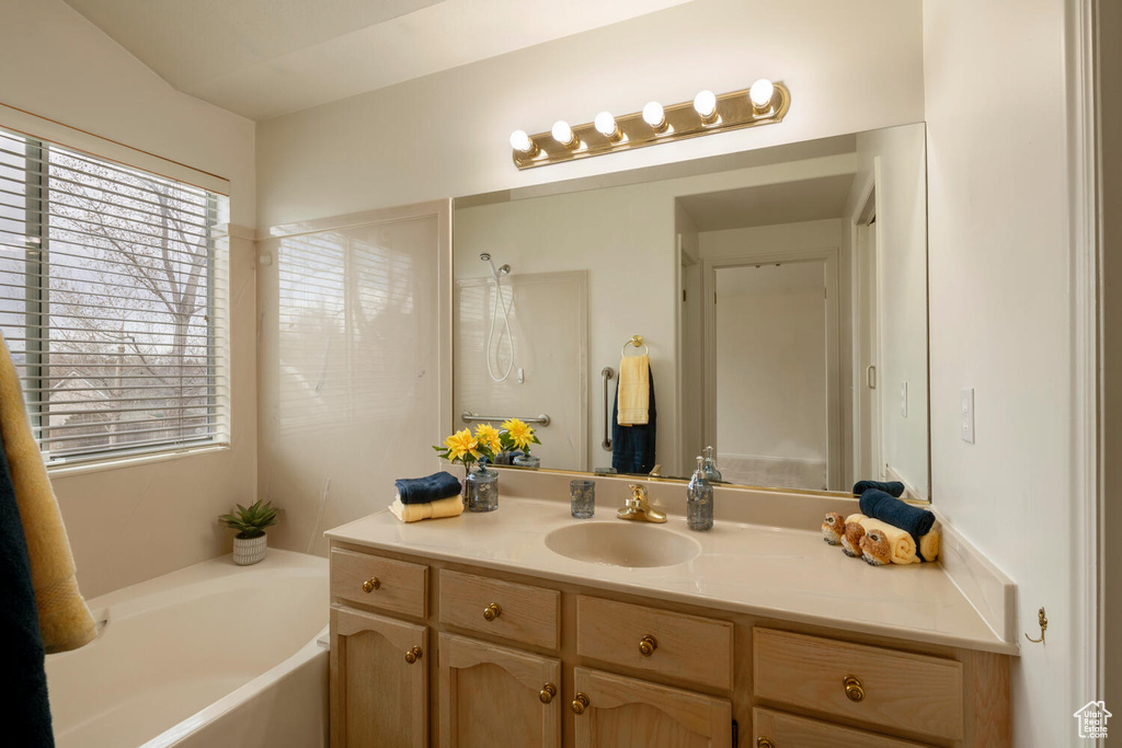 Bathroom with vanity and a bathing tub