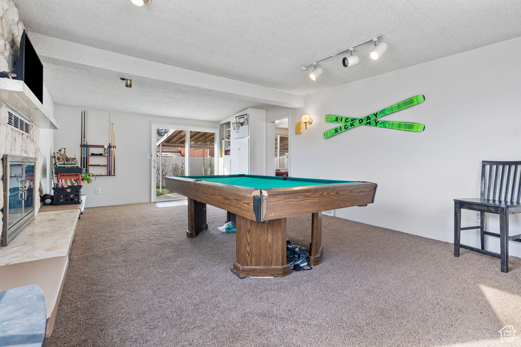 Recreation room with billiards, light colored carpet, a textured ceiling, and track lighting