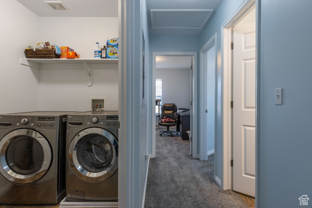 Laundry area featuring dark colored carpet, washer and clothes dryer, and hookup for a washing machine