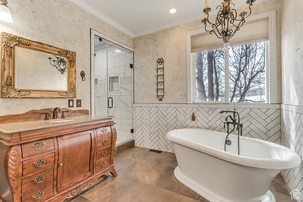 Bathroom featuring vanity, crown molding, tile flooring, a notable chandelier, and plus walk in shower