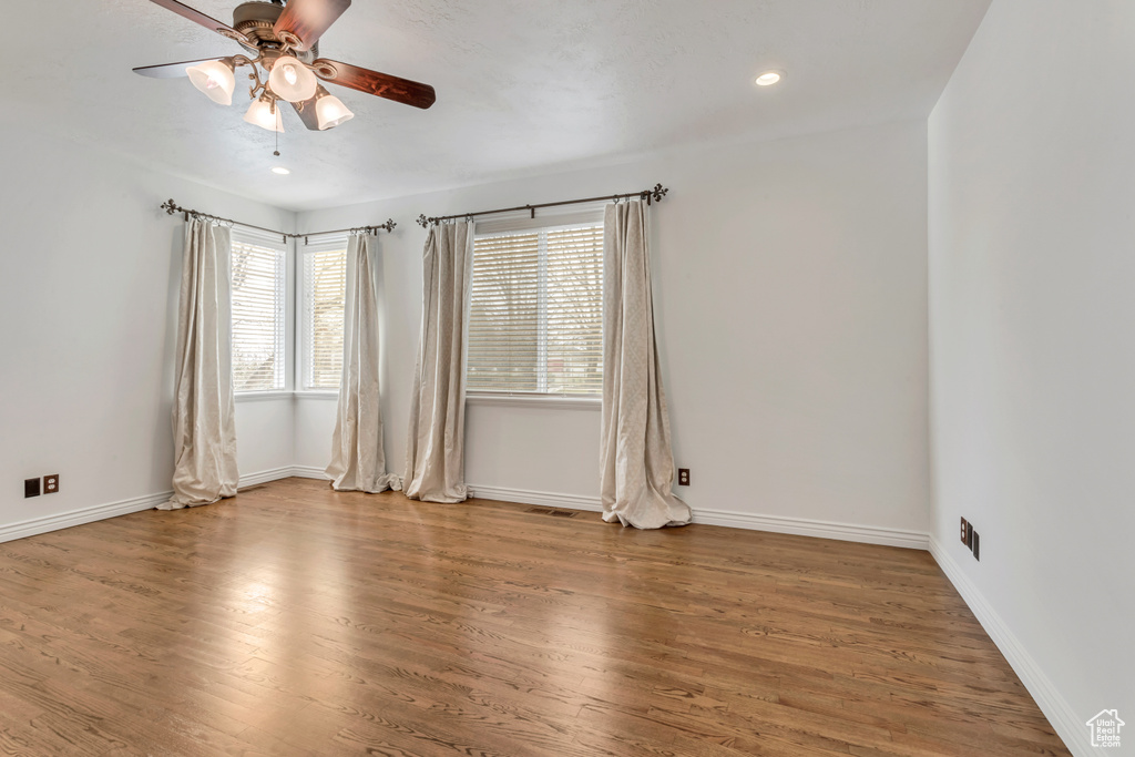 Spare room featuring ceiling fan and light hardwood / wood-style flooring