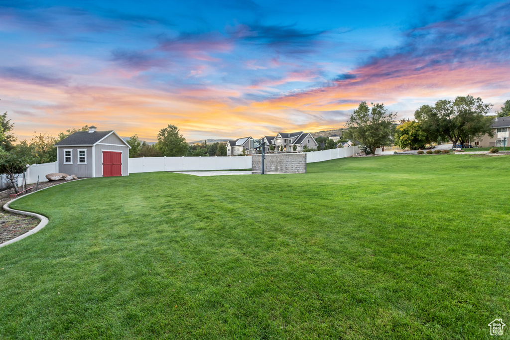 Yard at dusk with a storage shed