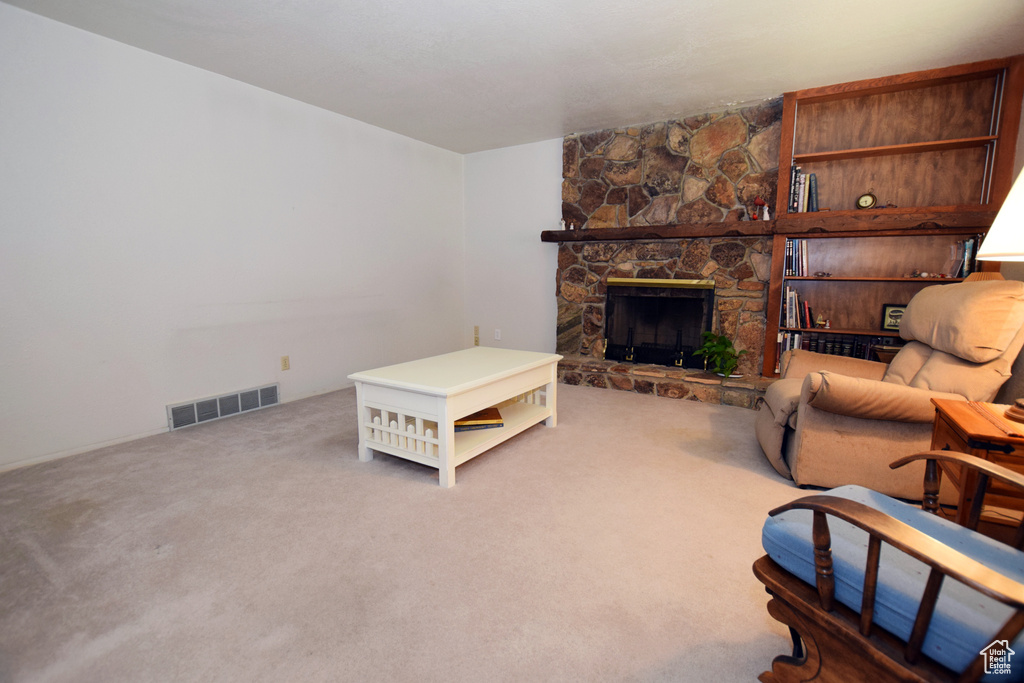 Living room with a fireplace and carpet