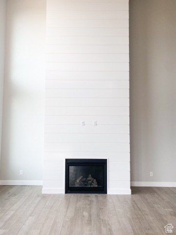 Details featuring a fireplace and light hardwood / wood-style floors