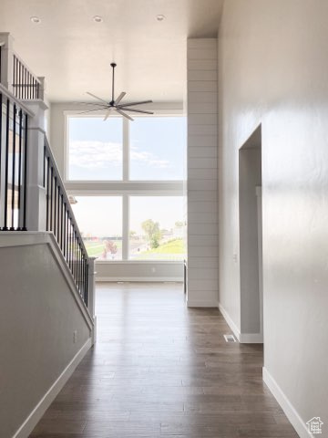Interior space featuring plenty of natural light, dark wood-type flooring, and ceiling fan