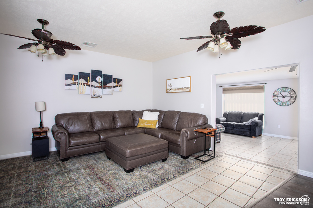 Living room with light tile flooring and ceiling fan