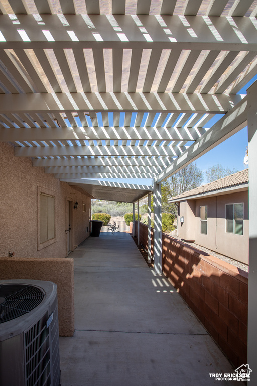 View of patio featuring a carport, central AC unit, and a pergola