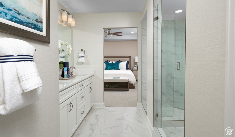 Bathroom featuring tile floors, vanity, ceiling fan, and a shower with shower door