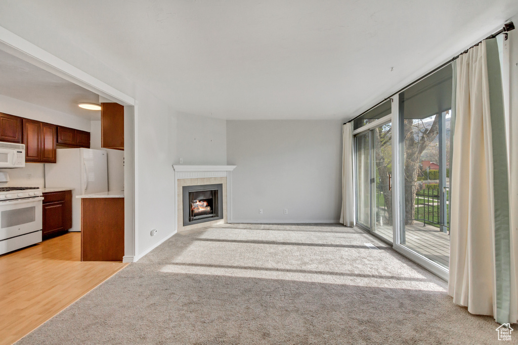 Unfurnished living room featuring a fireplace and light wood-type flooring