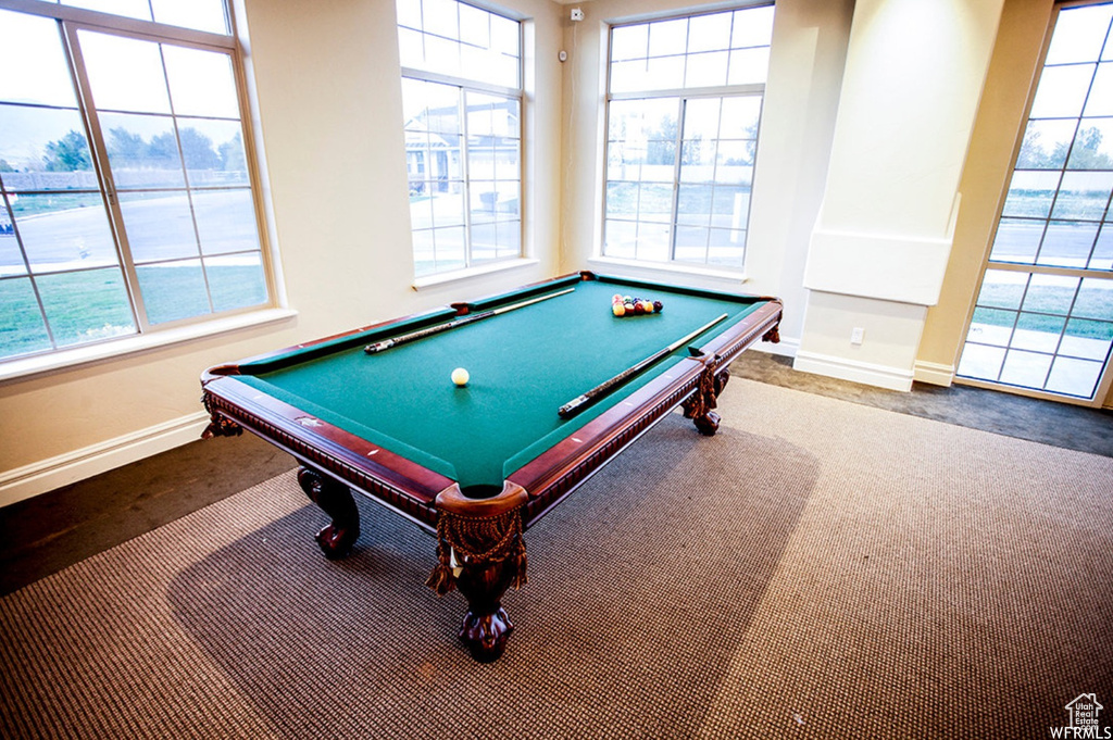 Playroom featuring billiards, dark colored carpet, and a healthy amount of sunlight