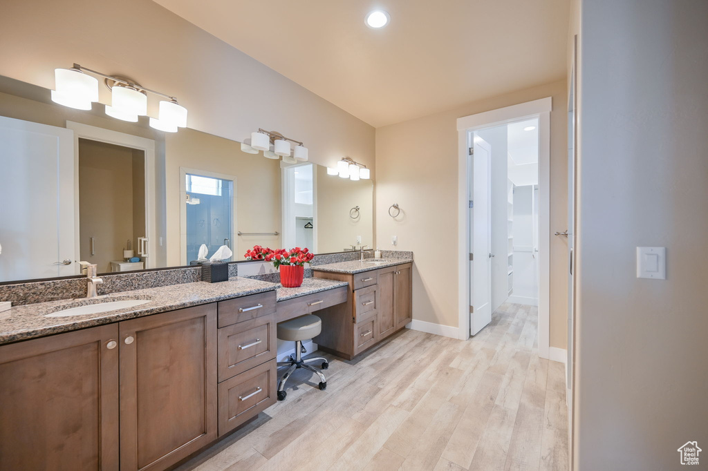 Bathroom with hardwood / wood-style floors and double sink vanity
