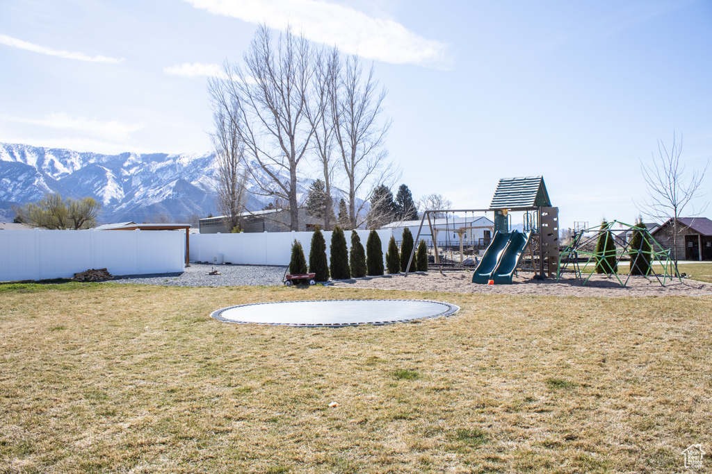 View of yard with a playground and a mountain view