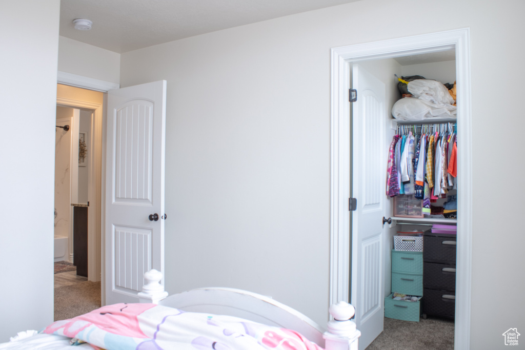 Bedroom with a closet and light colored carpet