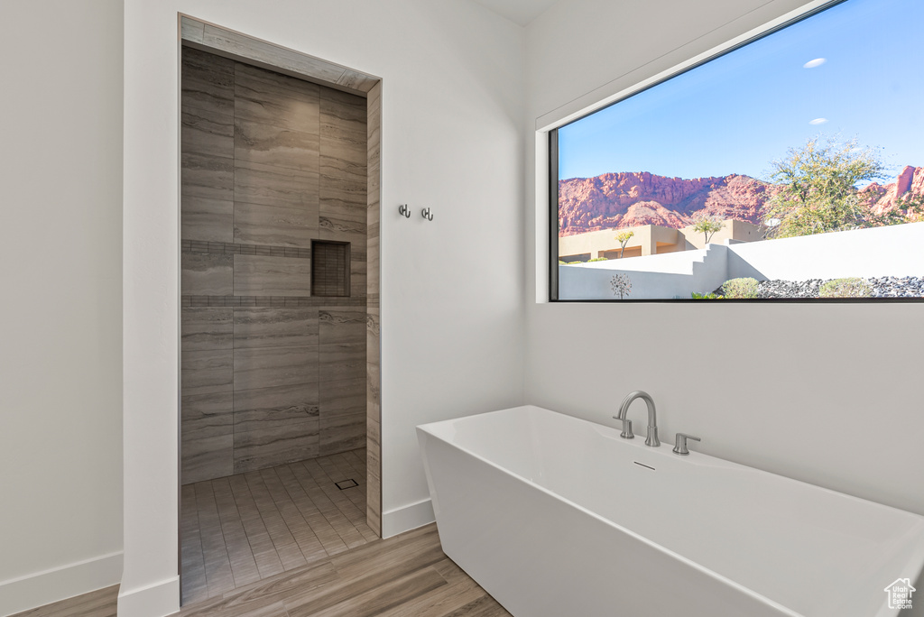 Bathroom featuring separate shower and tub, wood-type flooring, and a mountain view