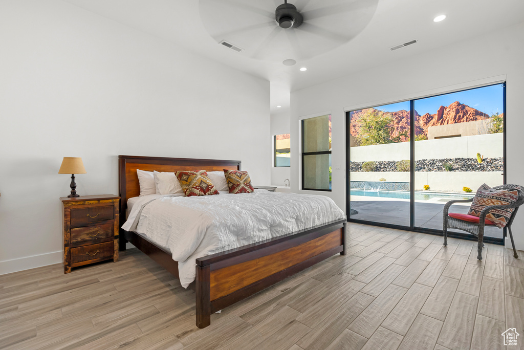 Bedroom featuring access to exterior, light wood-type flooring, and ceiling fan