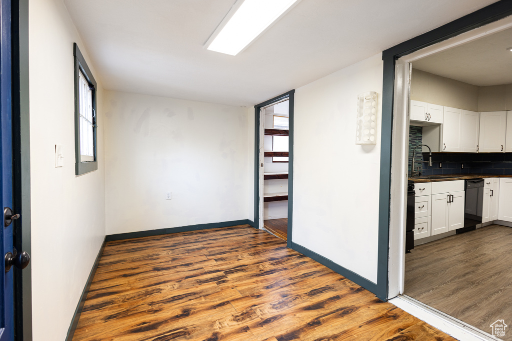 Spare room featuring plenty of natural light, dark hardwood / wood-style flooring, and sink