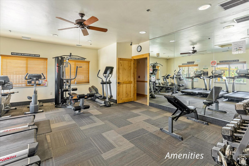 Gym with dark colored carpet and ceiling fan