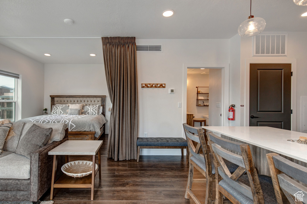 Dining space with dark hardwood / wood-style floors