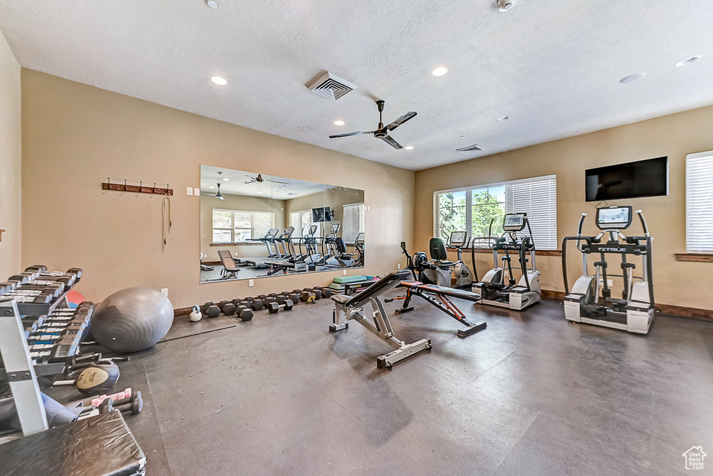 Gym featuring a textured ceiling and ceiling fan