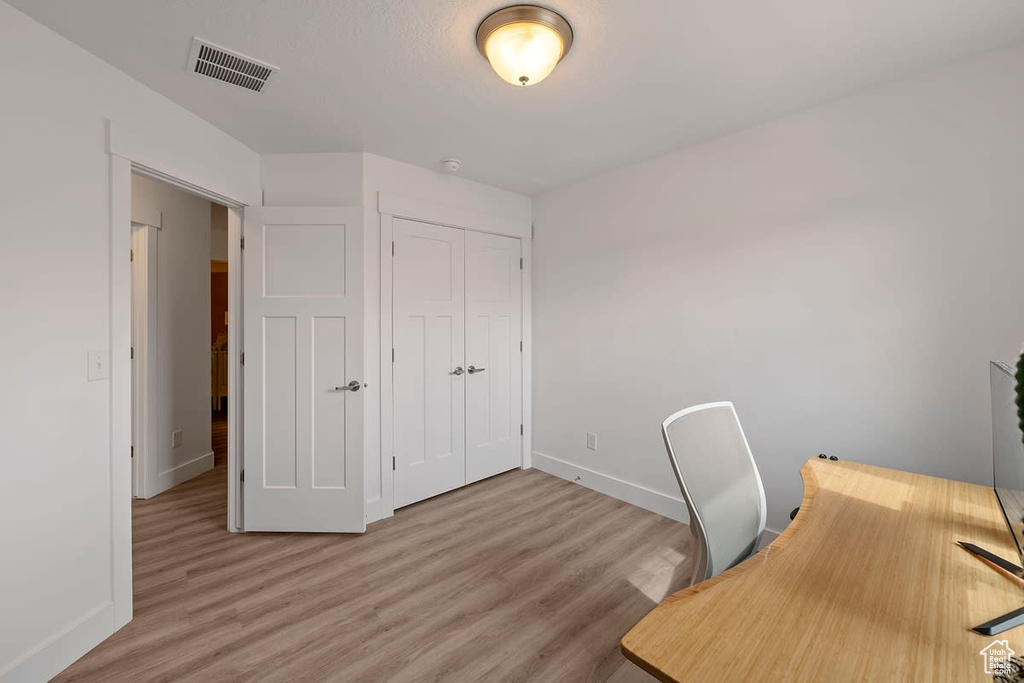 Unfurnished office with light hardwood / wood-style floors