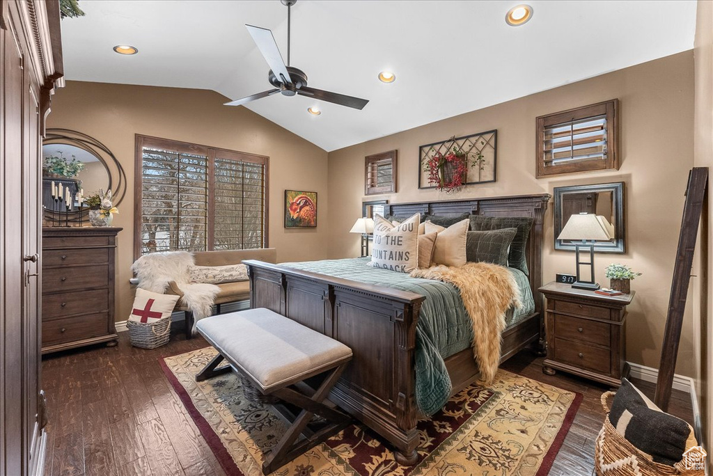 Bedroom with lofted ceiling, dark wood-type flooring, and ceiling fan
