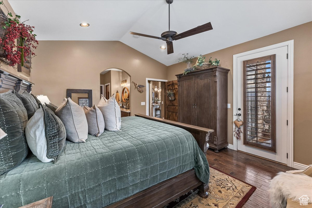 Bedroom with ceiling fan, lofted ceiling, dark hardwood / wood-style floors, and access to outside
