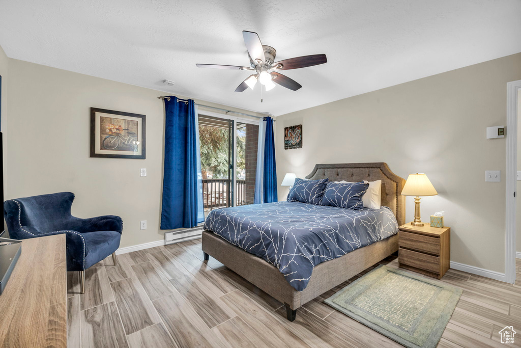 Bedroom with access to exterior, ceiling fan, and light hardwood / wood-style flooring