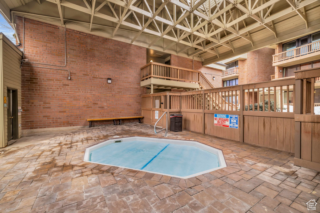 View of pool featuring a hot tub