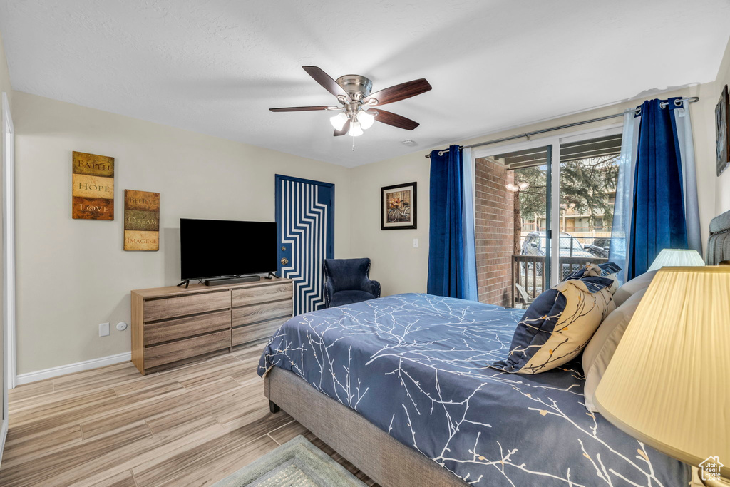 Bedroom featuring ceiling fan, light wood-type flooring, and access to outside
