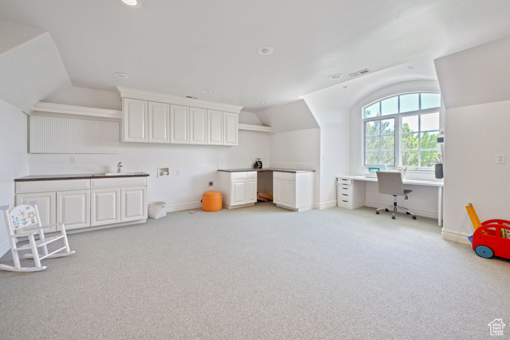 Playroom with light carpet, sink, and vaulted ceiling