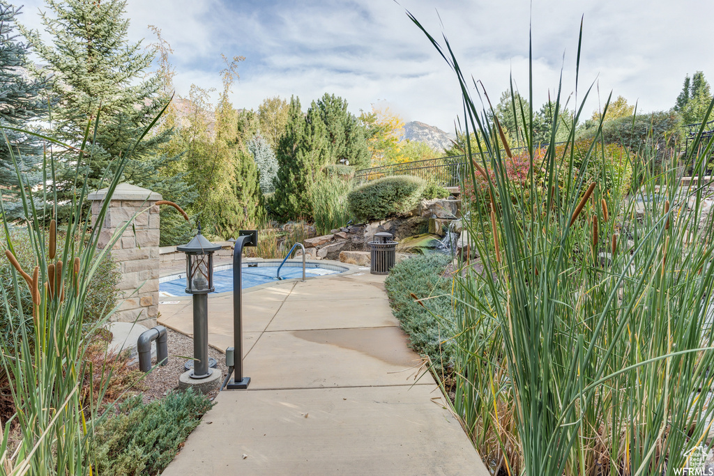 View of property's community featuring a patio, a mountain view, and a swimming pool