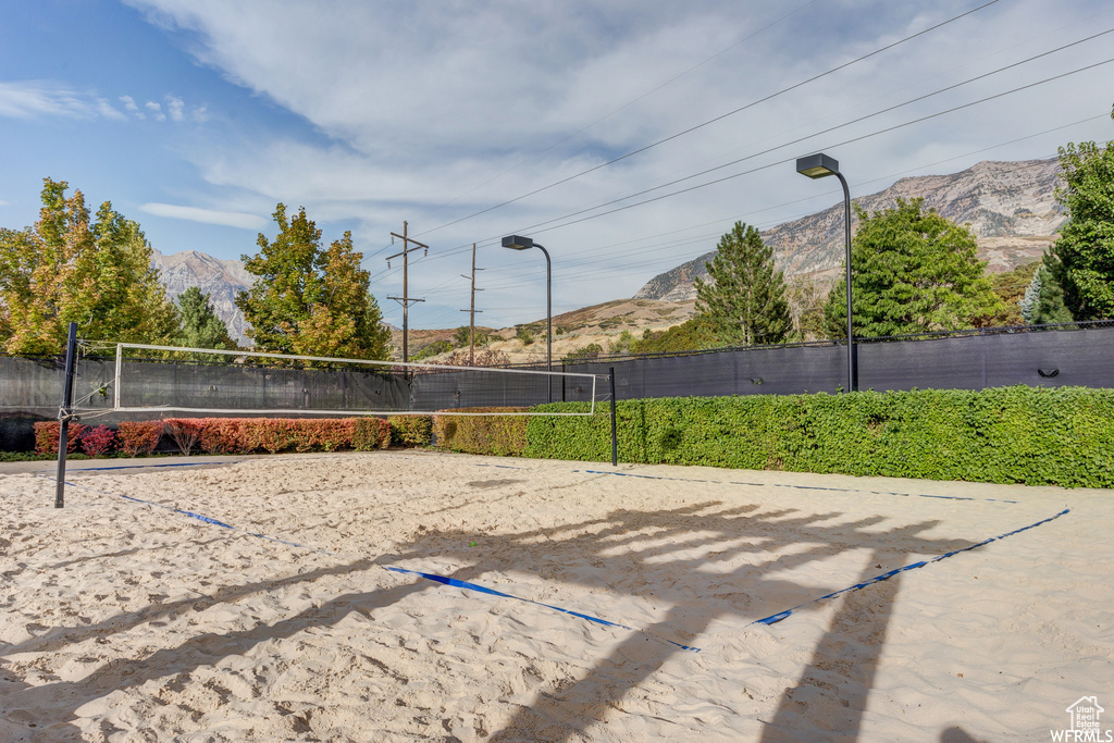 Surrounding community with a mountain view and volleyball court