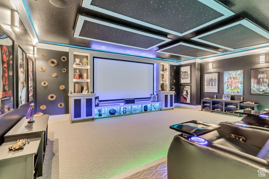 Home theater room featuring built in shelves, carpet flooring, and coffered ceiling
