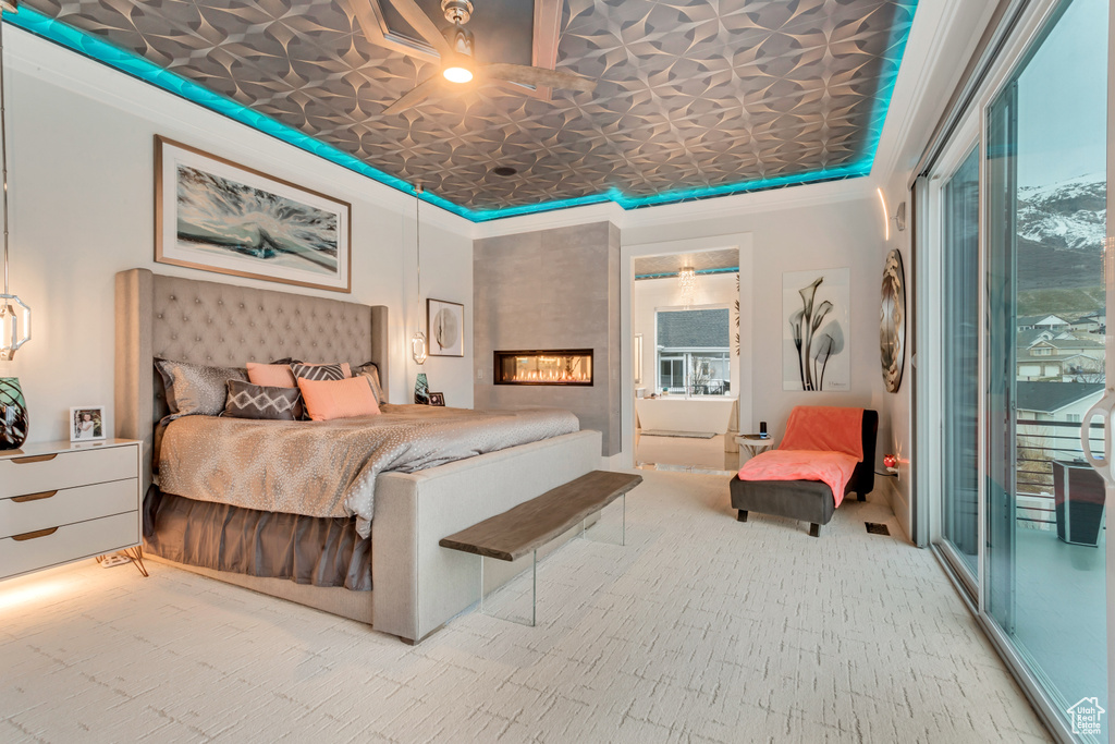 Bedroom with light colored carpet, ornamental molding, and connected bathroom