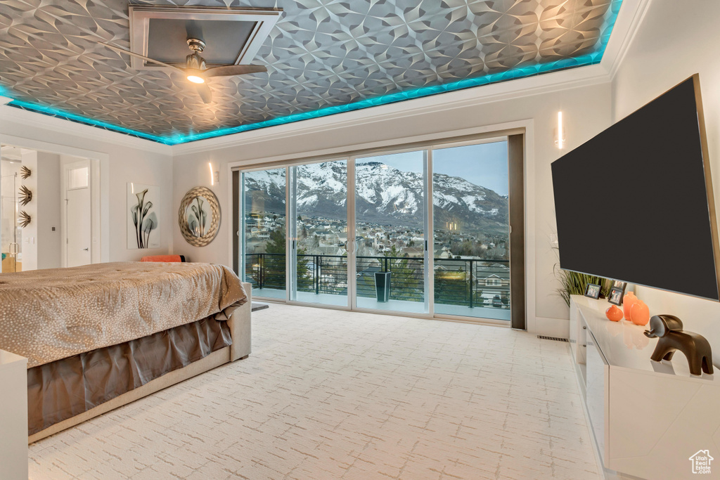 Bedroom featuring ornamental molding, access to outside, and a mountain view