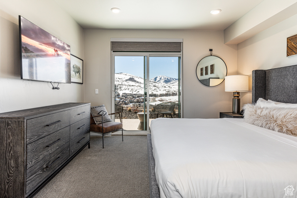 Carpeted bedroom with a mountain view