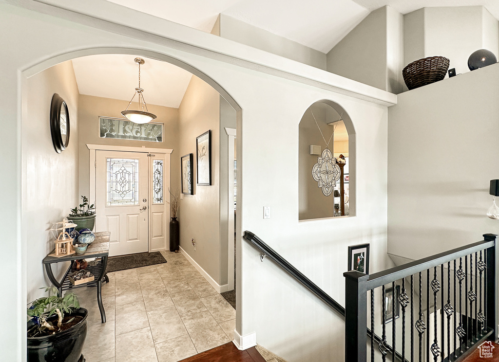 Foyer featuring vaulted ceiling and light tile flooring