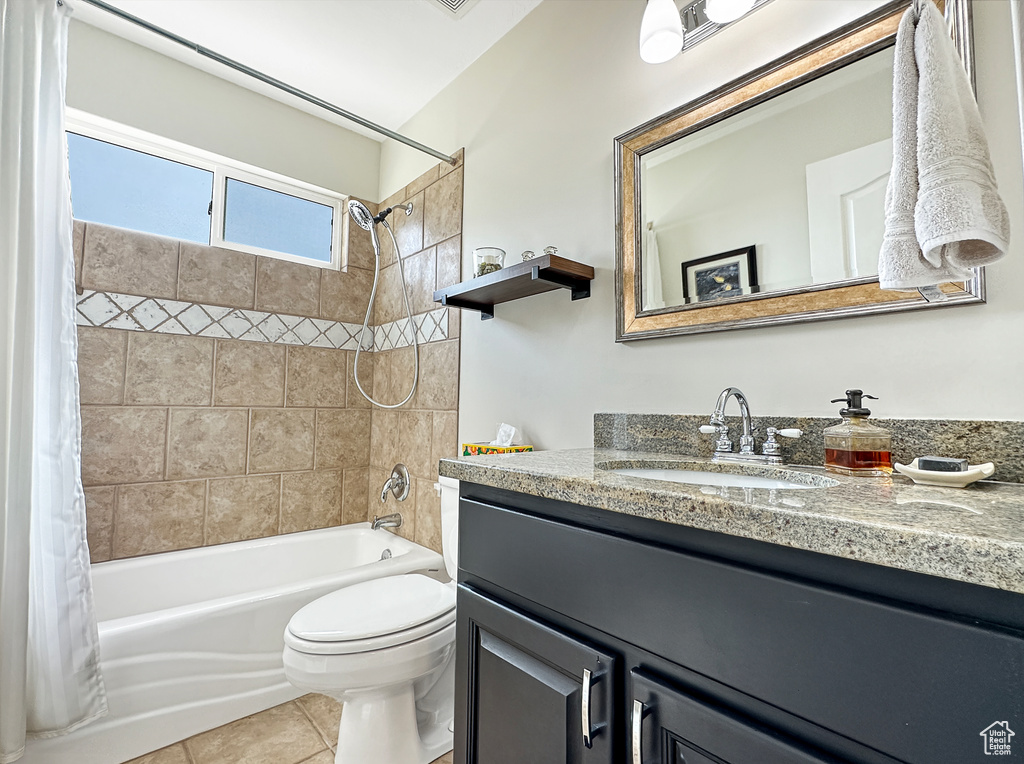 Full bathroom featuring vanity, toilet, tile flooring, and shower / bath combo