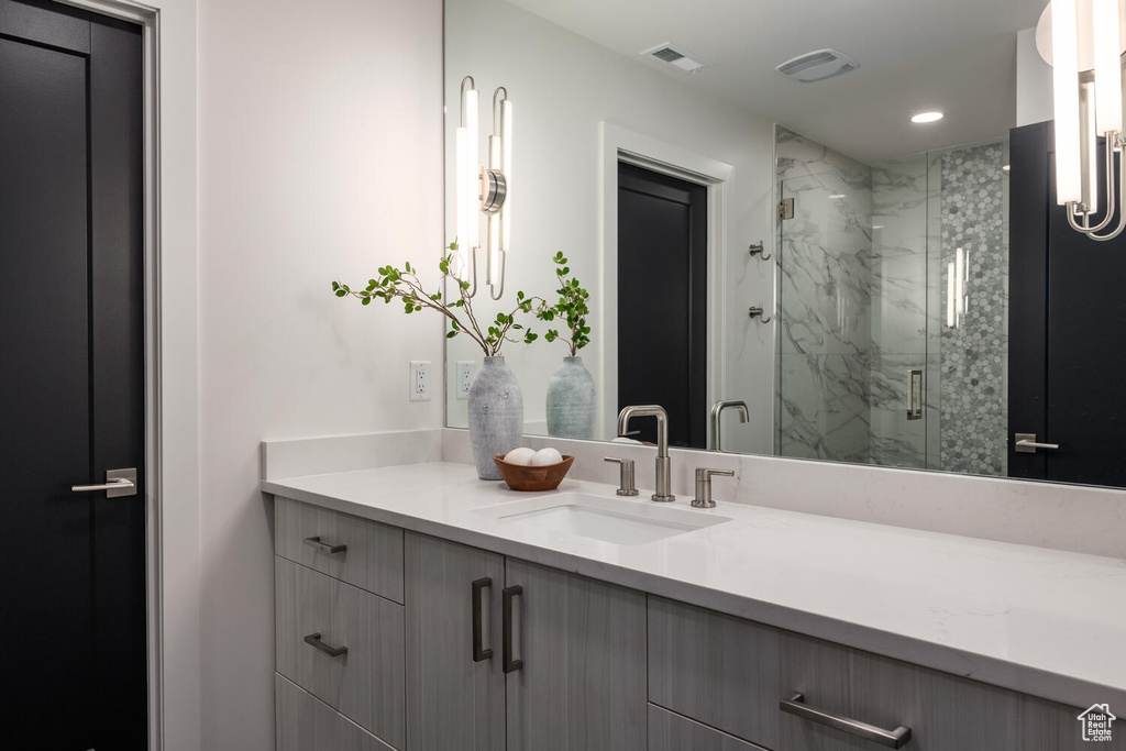 Bathroom featuring walk in shower and vanity