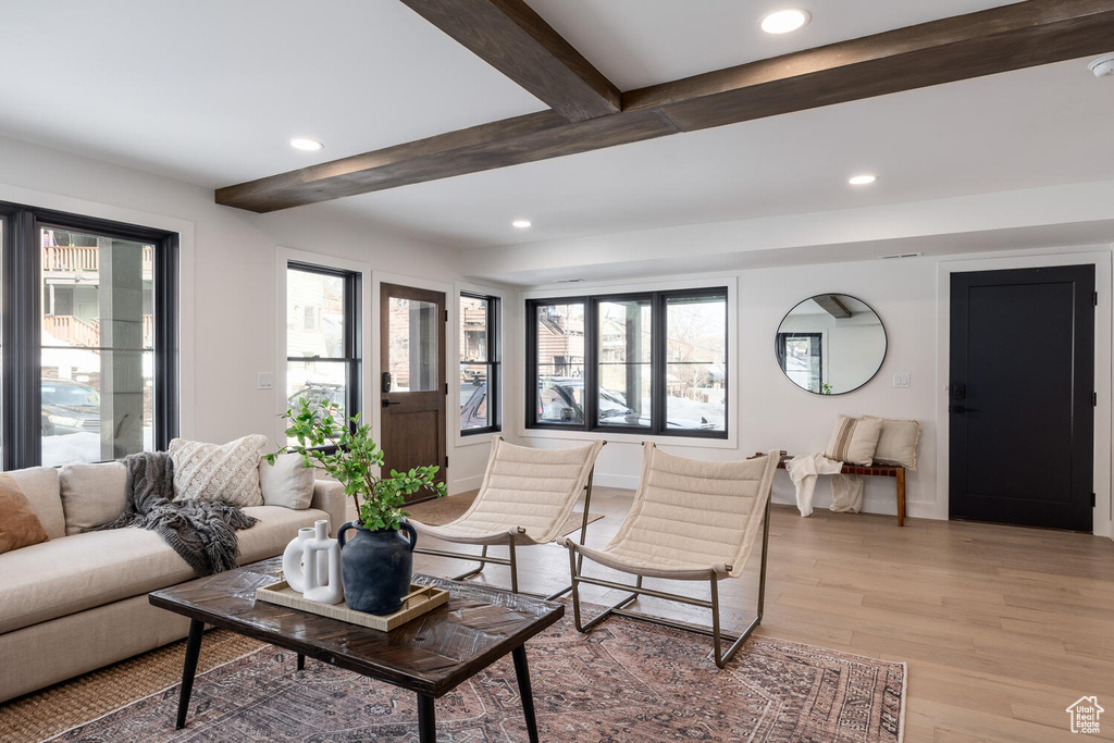 Living room featuring beamed ceiling and light hardwood / wood-style floors