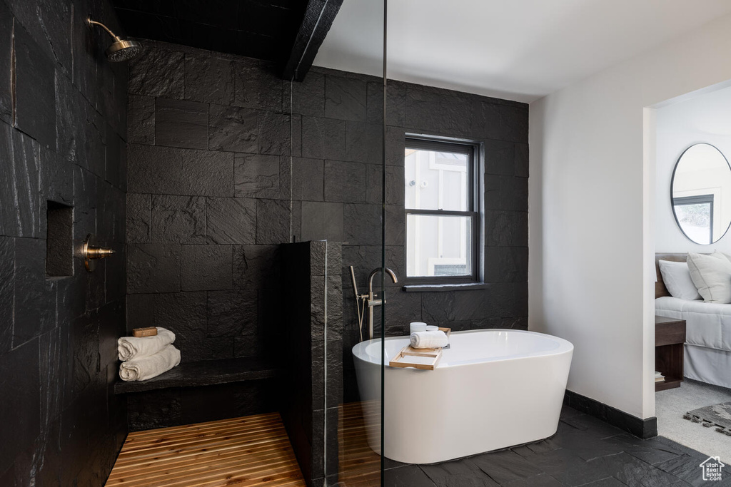 Bathroom with wood-type flooring, beamed ceiling, tile walls, and plus walk in shower