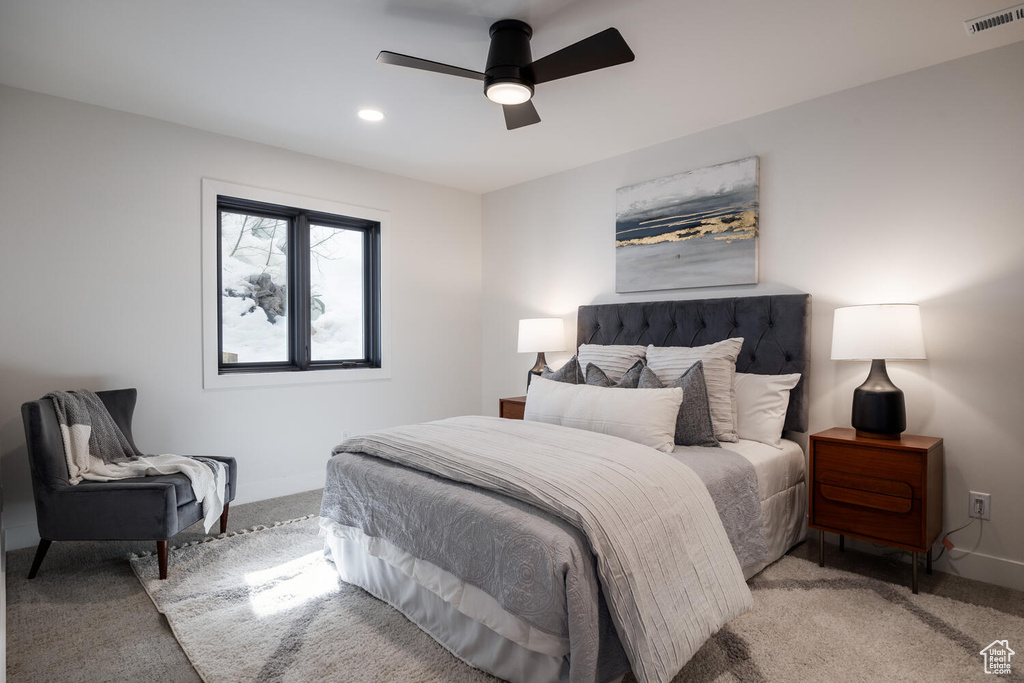 Carpeted bedroom with ceiling fan