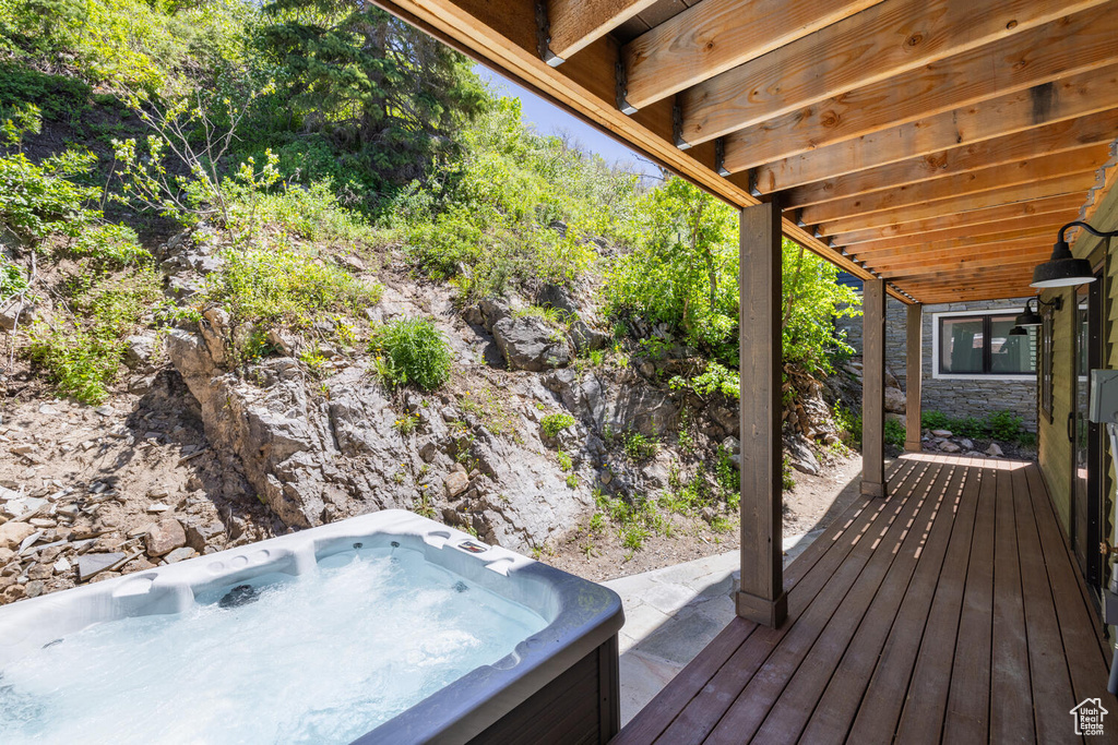 Wooden terrace featuring a hot tub