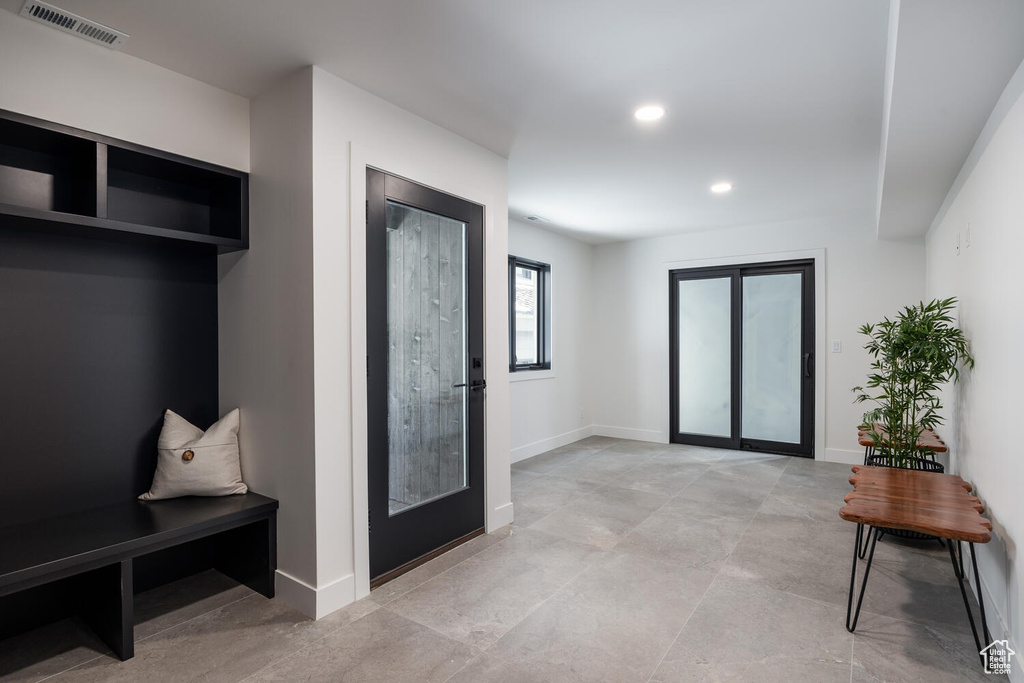 Interior space with french doors and light tile flooring