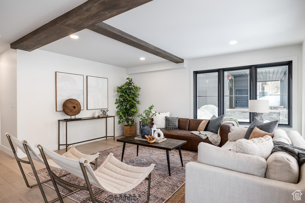 Living room with beamed ceiling and hardwood / wood-style floors